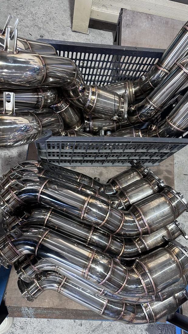 Finished stainless headers in production baskets awaiting QC