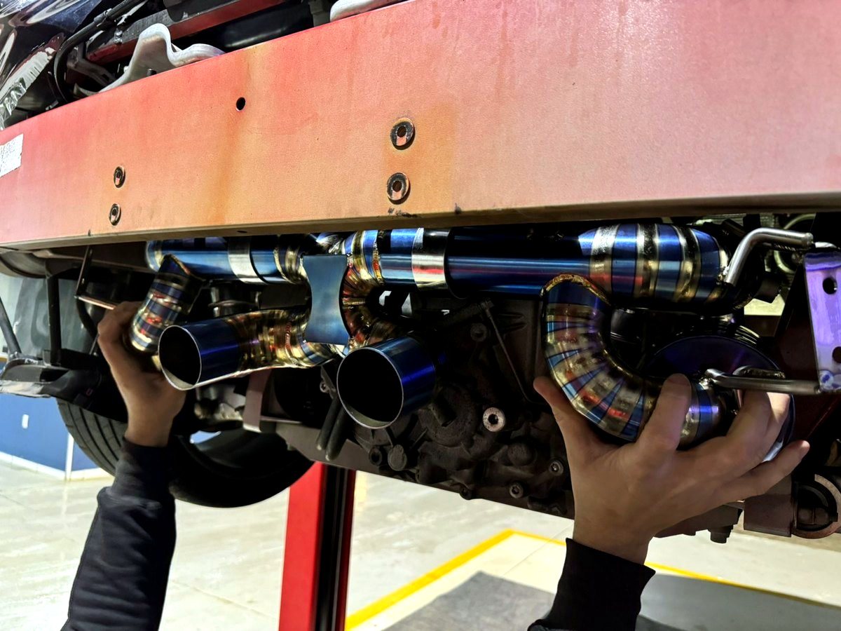 Ferrari 458 Italia OUCHI titanium downpipe and exhaust detail during installation — customer photo