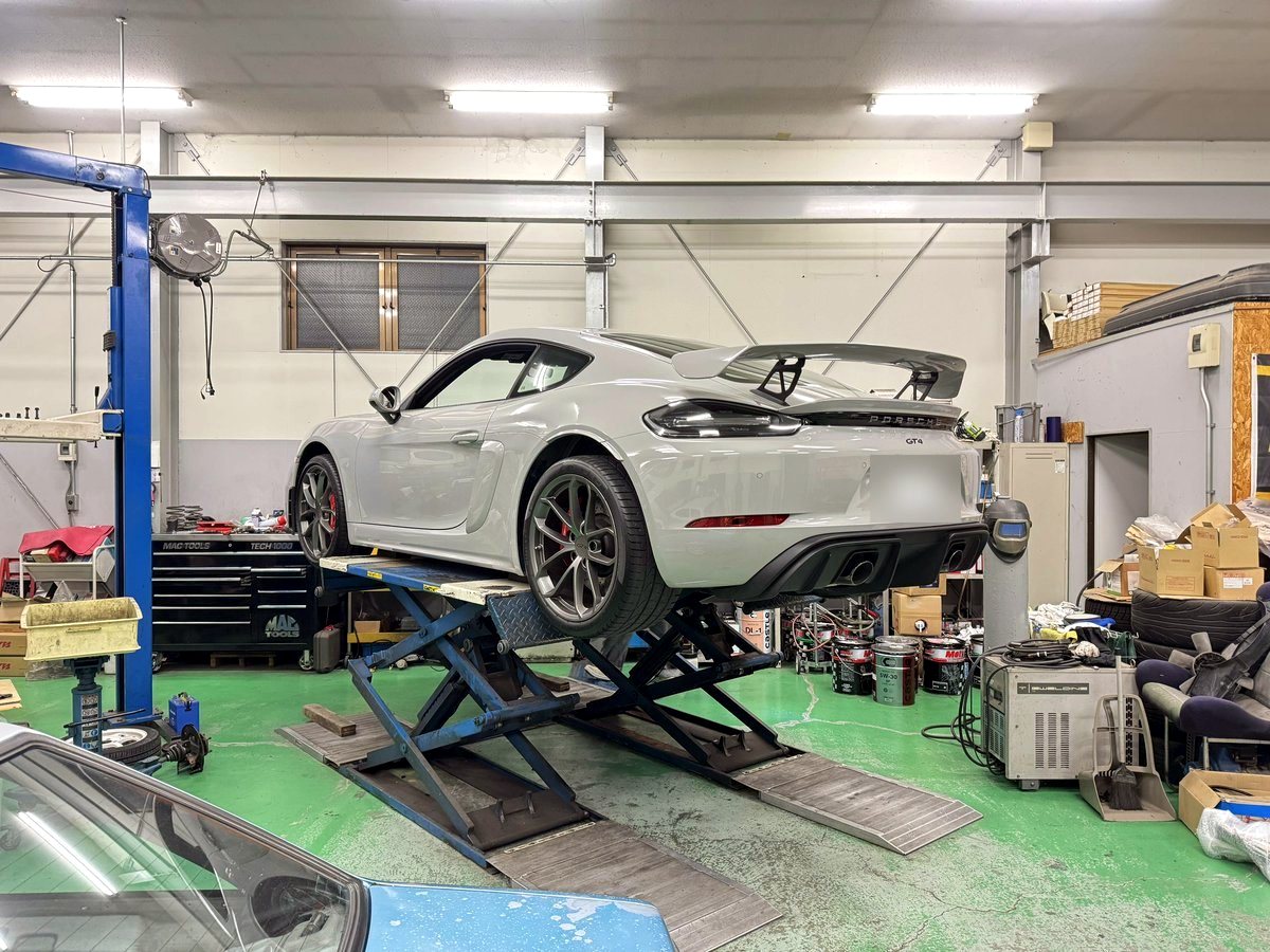 Porsche 718 Cayman GT4 in the workshop with OUCHI mid-rear exhaust — customer installation