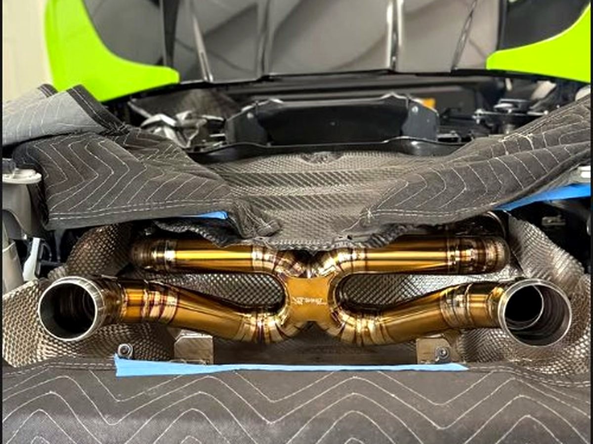 McLaren 720S OUCHI titanium dual X-pipe with branded heat shields — customer installation