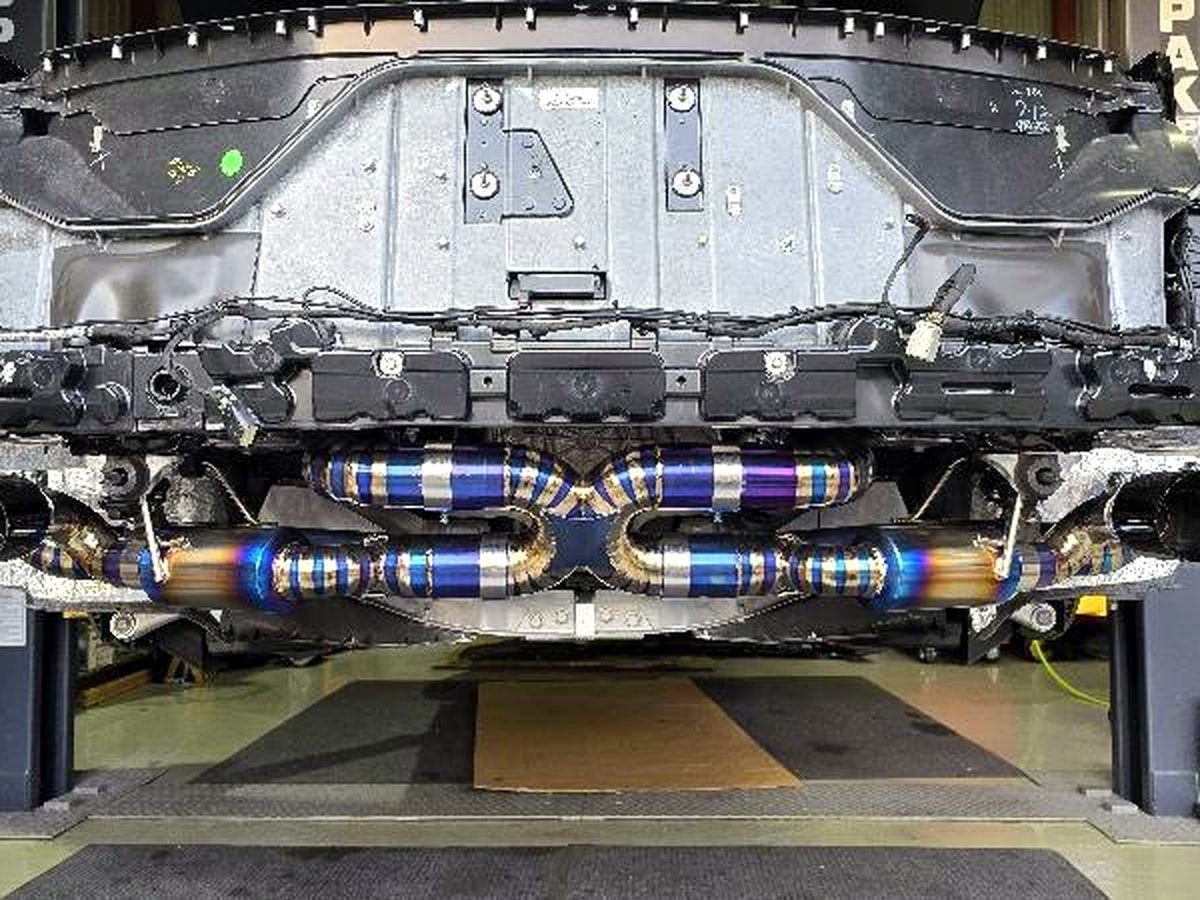 Corvette C8 underbody — OUCHI titanium valved exhaust, symmetrical routing — customer installation