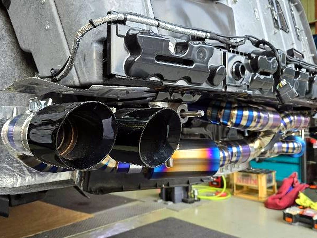 Corvette C8 OUCHI titanium valved exhaust, black quad tips closeup — customer installation