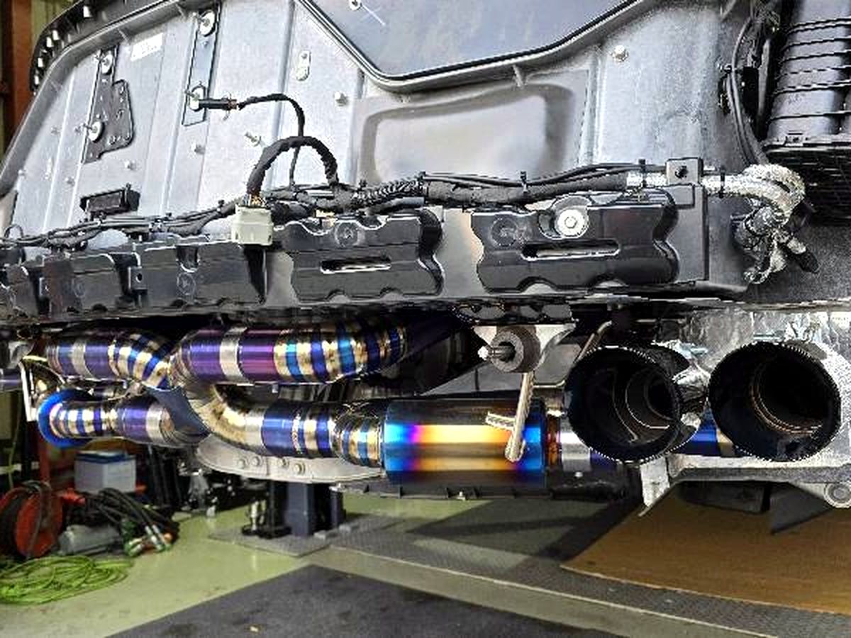 Corvette C8 underbody with OUCHI titanium valved exhaust and quad black tips — customer installation