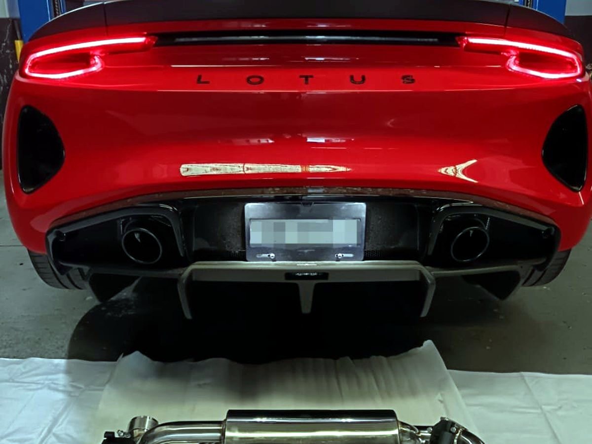 Lotus Emira 3.5 V6 rear with OUCHI T304 stainless valved exhaust fitted, dual tips below the LED taillights — customer installation