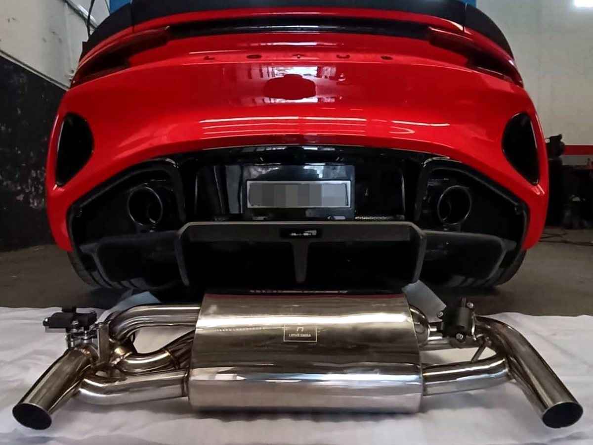 Lotus Emira 3.5 V6 rear with OUCHI T304 stainless valved rear section laid out for fitment — customer installation