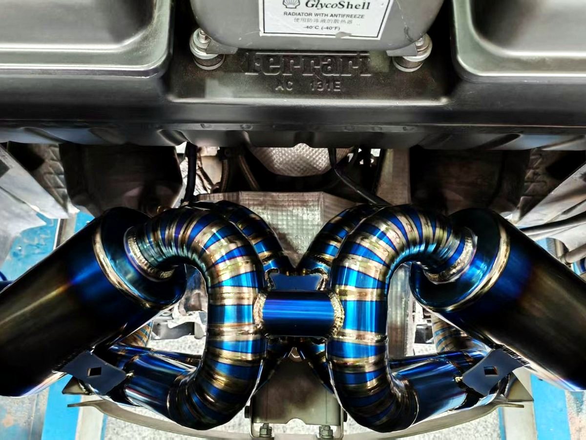 Ferrari F430 with OUCHI titanium exhaust, symmetrical routing under the engine — customer installation