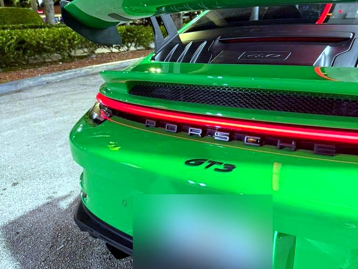 Green Porsche 992 GT3 at night with OUCHI stainless exhaust — customer photo