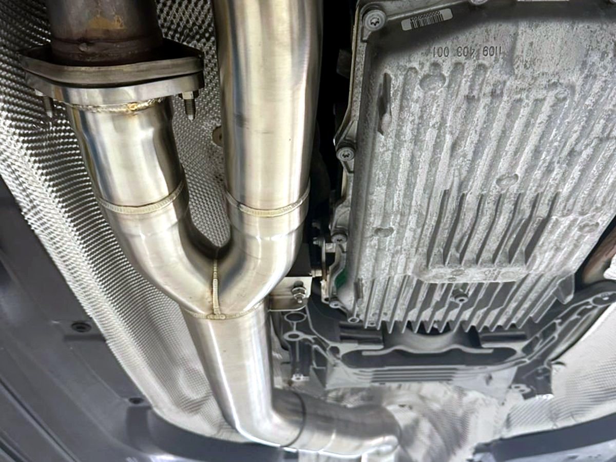 BMW M3 G80 underbody with OUCHI stainless steel mid-pipe — customer installation