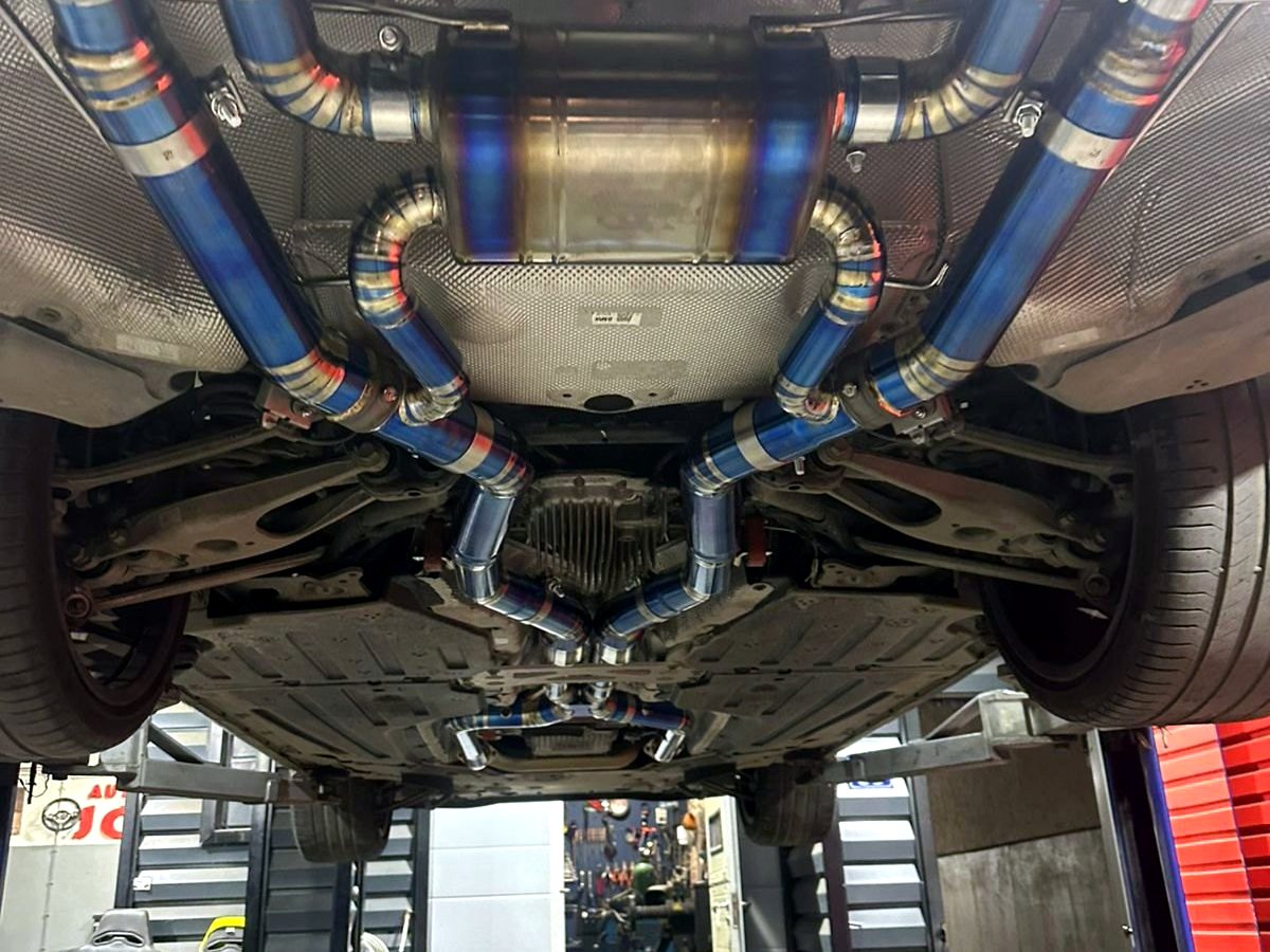 BMW M3 G80 underbody with OUCHI titanium mid-rear exhaust — customer installation