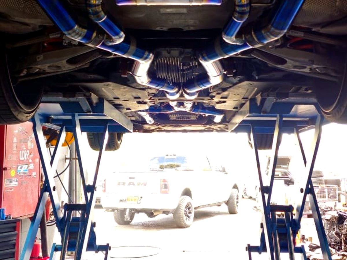 BMW M3 / M4 G8X underbody with OUCHI titanium valved exhaust — customer installation