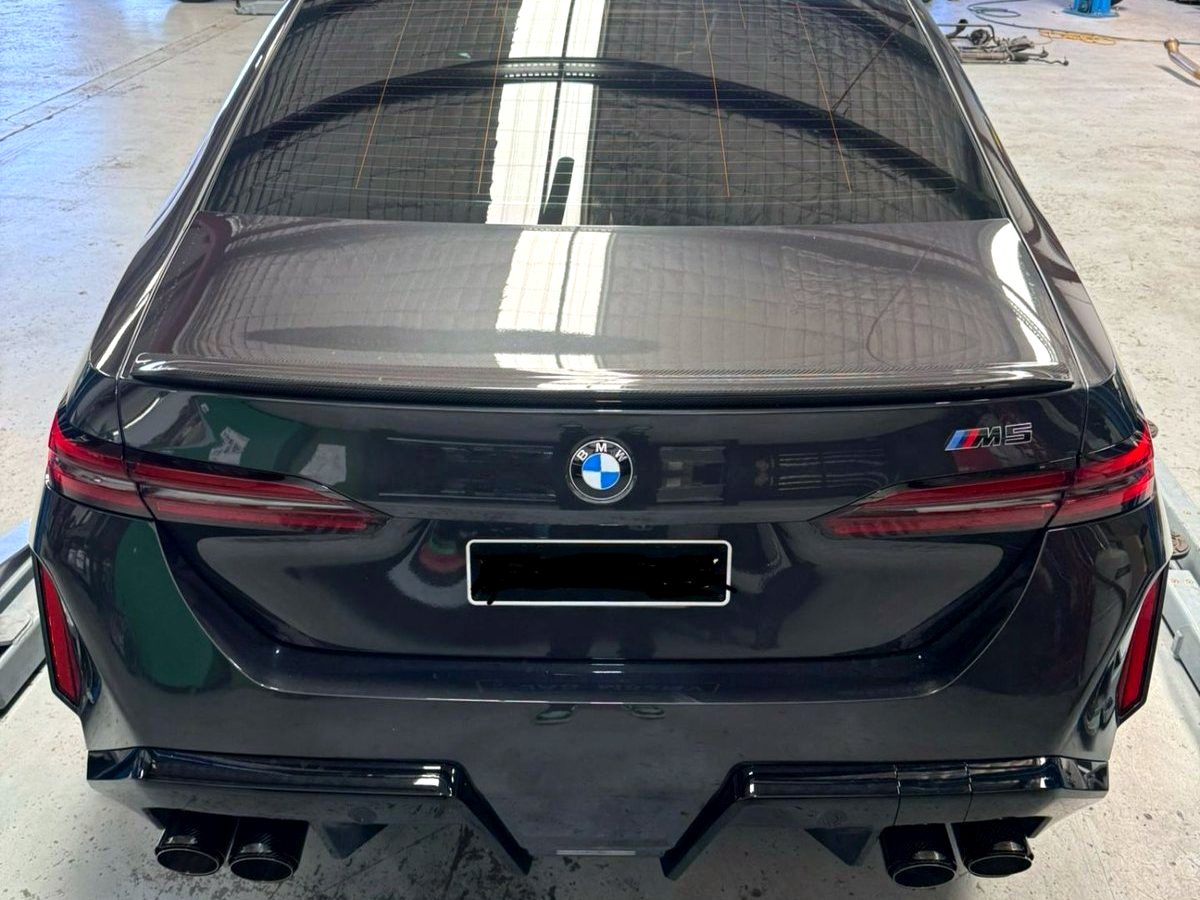 BMW M5 G90 rear with OUCHI exhaust quad tips fitted — customer photo