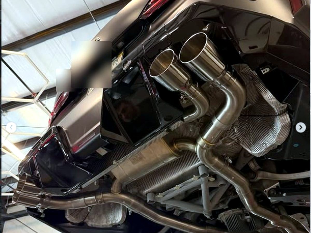 BMW M5 G90 rear with OUCHI valved stainless exhaust quad tips — customer installation