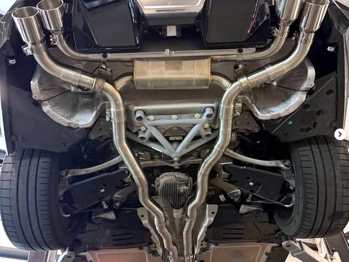 BMW M5 G90 underbody with OUCHI valved T304 stainless mid-rear exhaust — customer installation