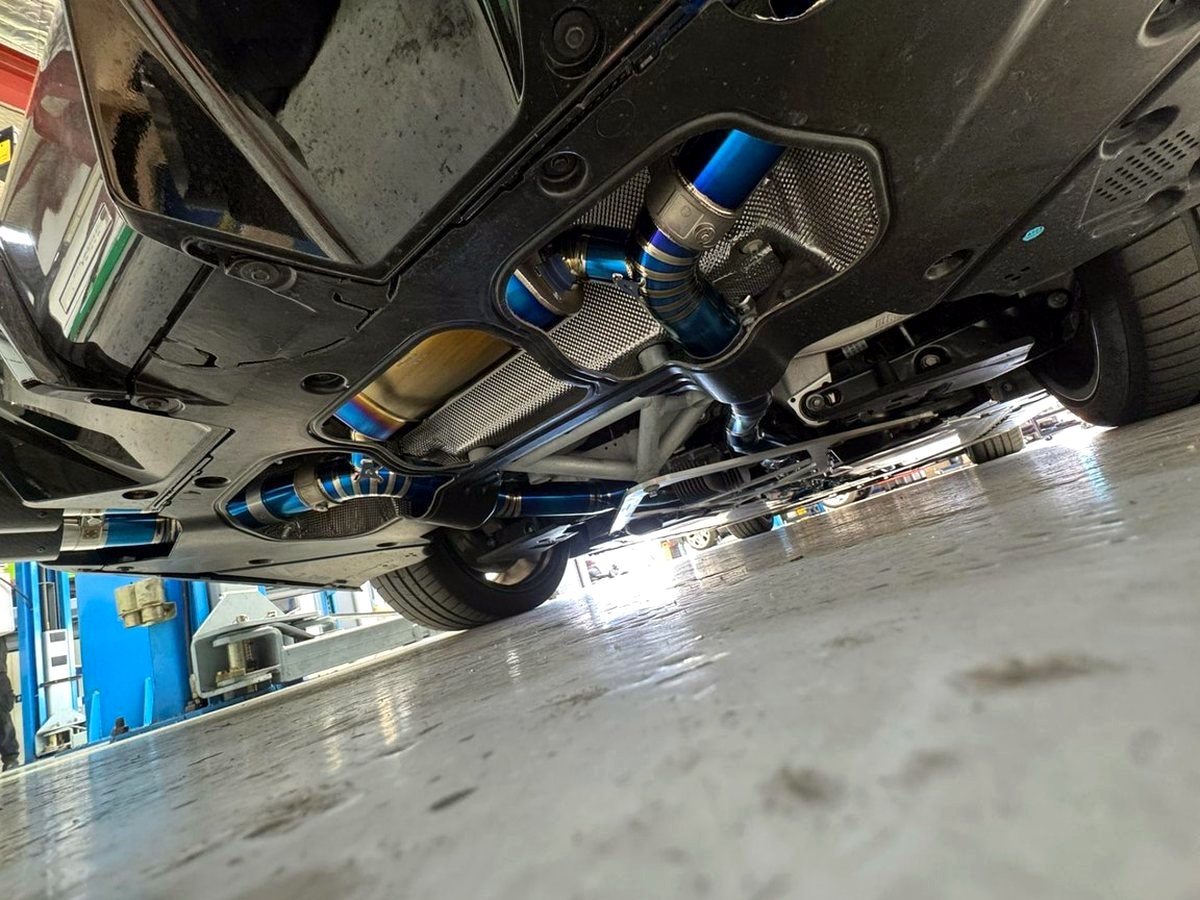 BMW M5 G90 titanium exhaust from below — rear diff and valve section — customer installation