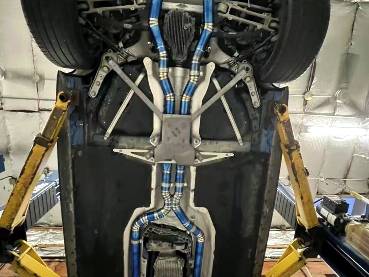 BMW M5 titanium valved exhaust routing along the underbody — customer installation