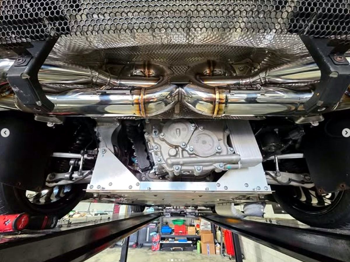 McLaren GT underbody with OUCHI T304 stainless valved exhaust and heat shielding — customer installation