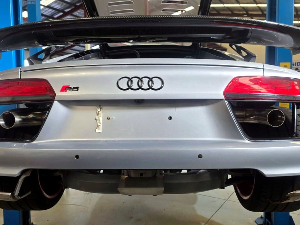 Audi R8 V10 rear with OUCHI dual X-pipe stainless exhaust, relocated custom outlets — customer installation
