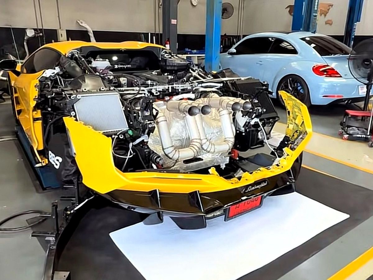 Lamborghini Revuelto V12 with OUCHI T304 stainless exhaust headers being fitted — customer installation