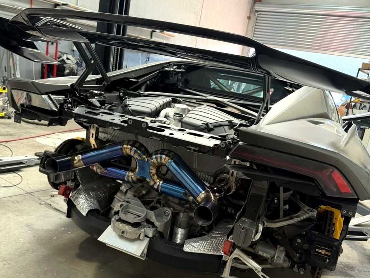 Lamborghini Huracan STO with OUCHI straight-piped titanium headers and rear section, blue heat-tinted — customer installation