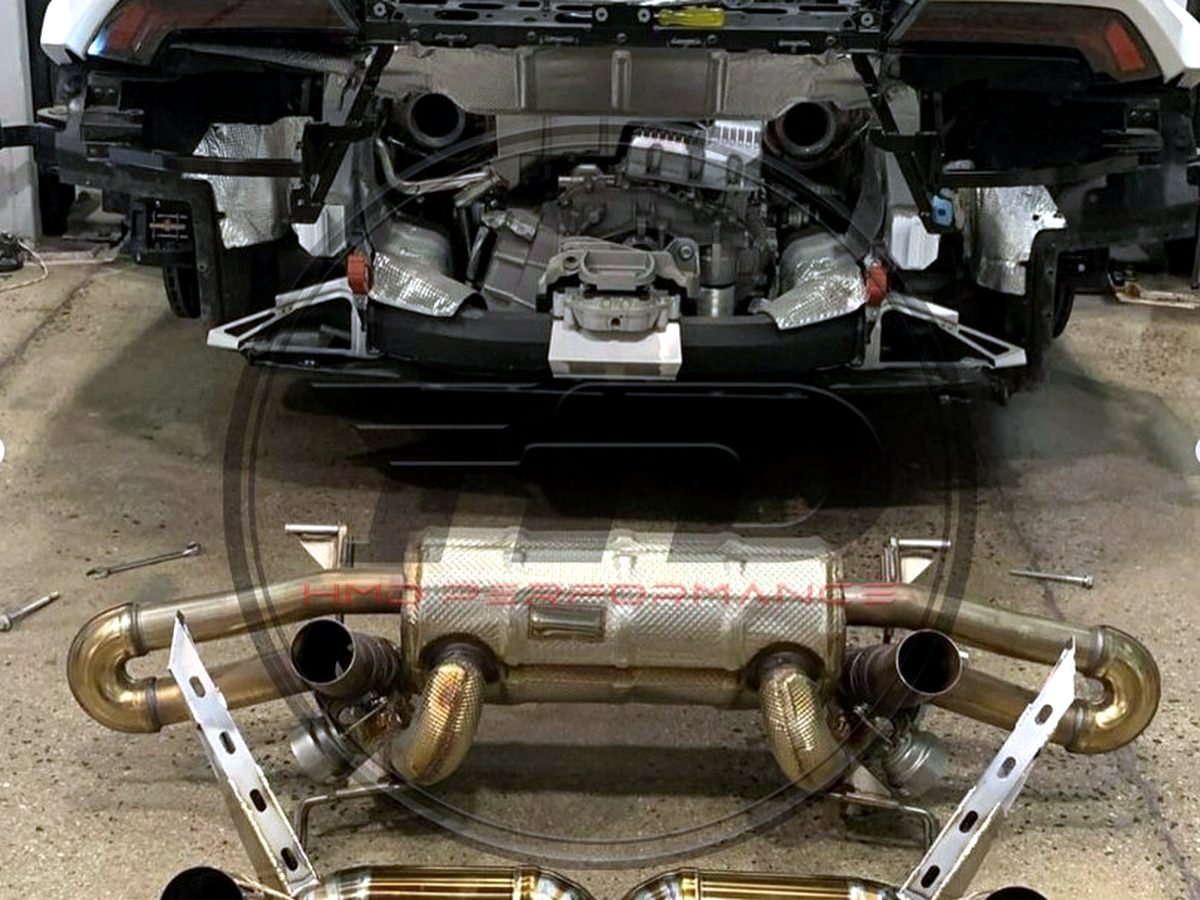 Lamborghini Huracan STO — OUCHI titanium exhaust kit laid out next to the stock system — customer installation