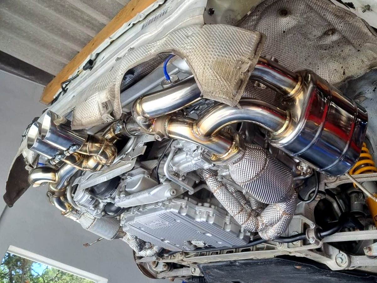 OUCHI full exhaust system underbody on a lift — customer installation