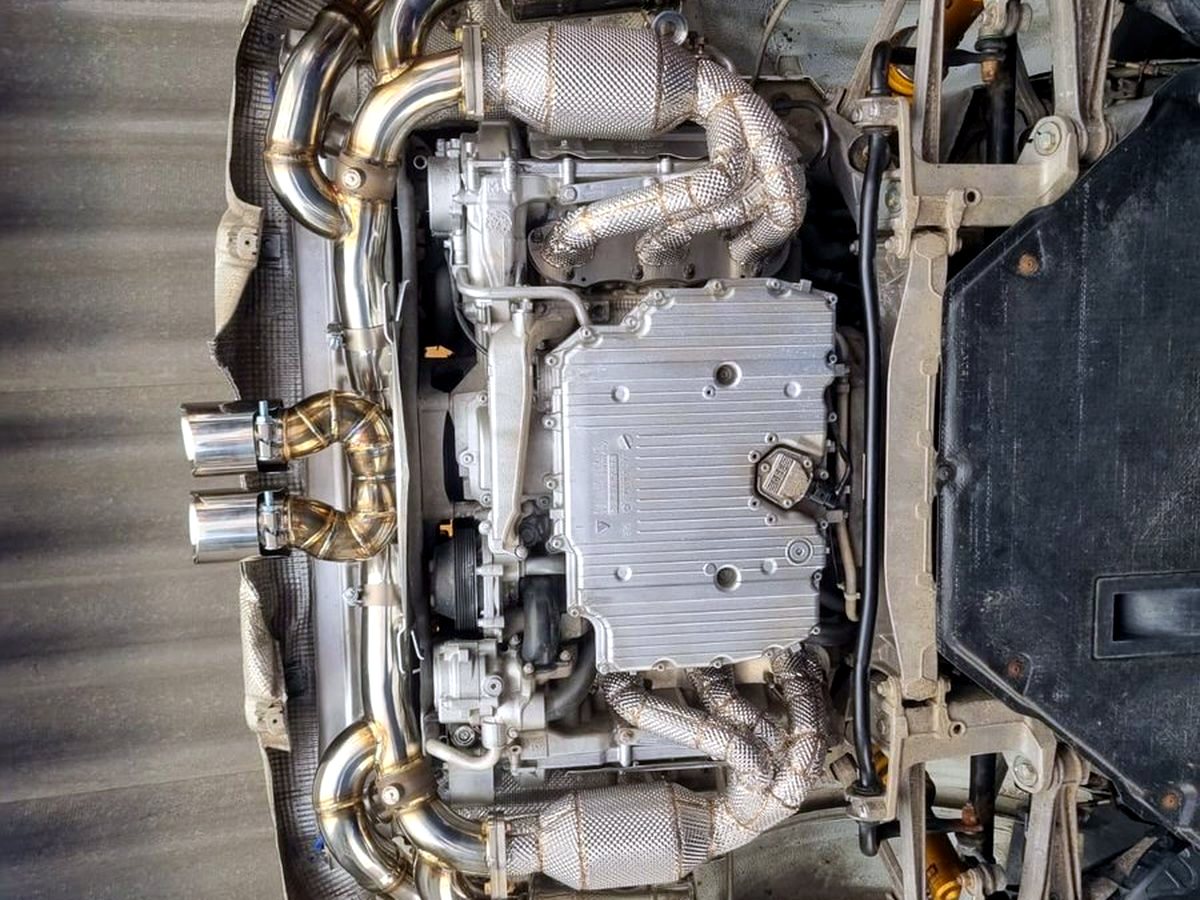 Full OUCHI exhaust system viewed from below — customer installation