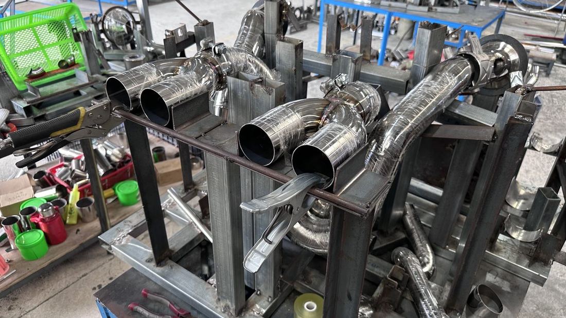 Stainless steel header sections clamped in a welding jig